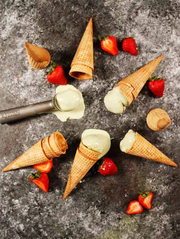 Ice cream in cones on a table.