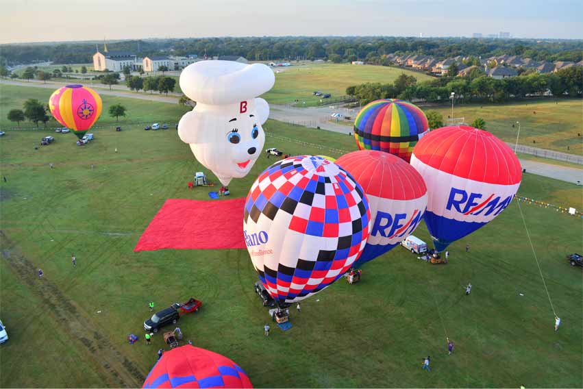 Hot air balloons in a field.