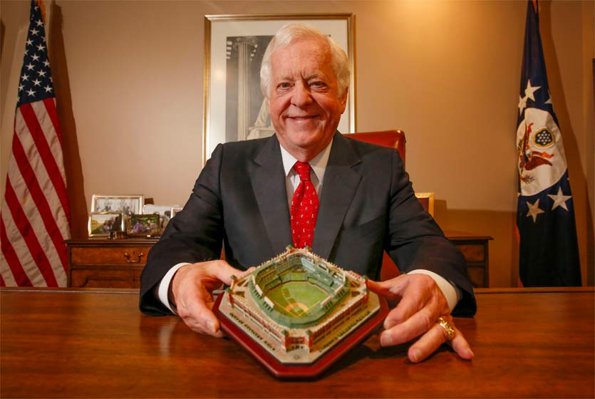 Man holding a minature baseball field.